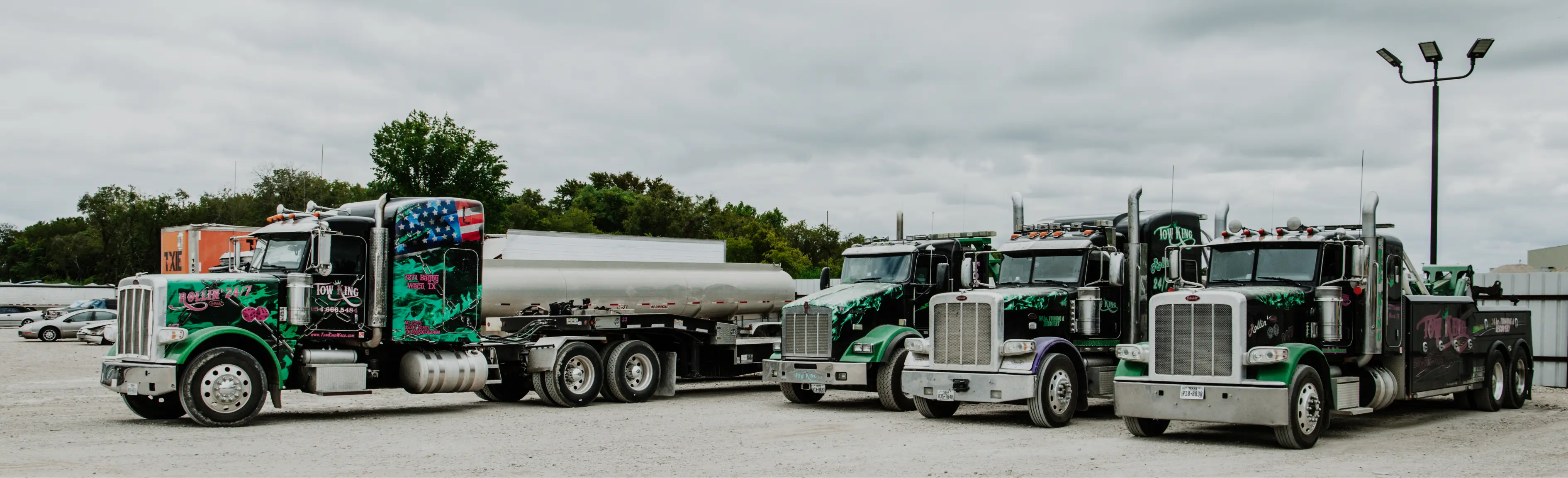 Heavy-duty tow and haul trucks parked in a fleet yard for LeCoop Truck and Trailer services
