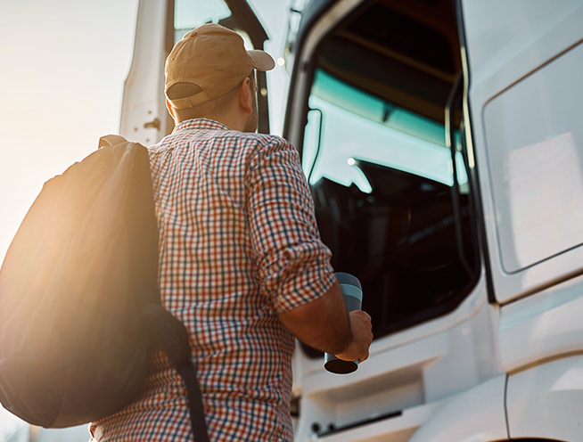 Truck driver preparing to step into a commercial truck cab for LeCoop Truck and Trailer fleet operations