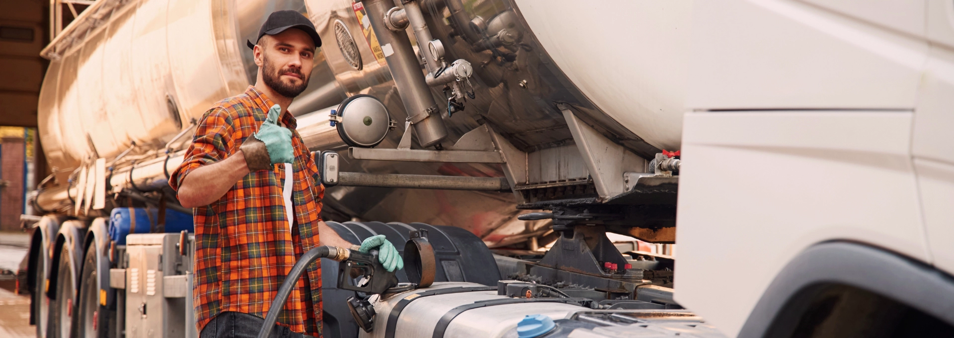 Truck driver refueling a commercial semi-truck at a station for LeCoop Truck and Trailer fleet services