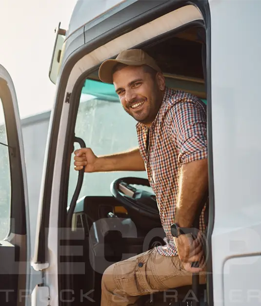 Smiling truck driver entering semi-truck cab for LeCoop Truck & Trailer